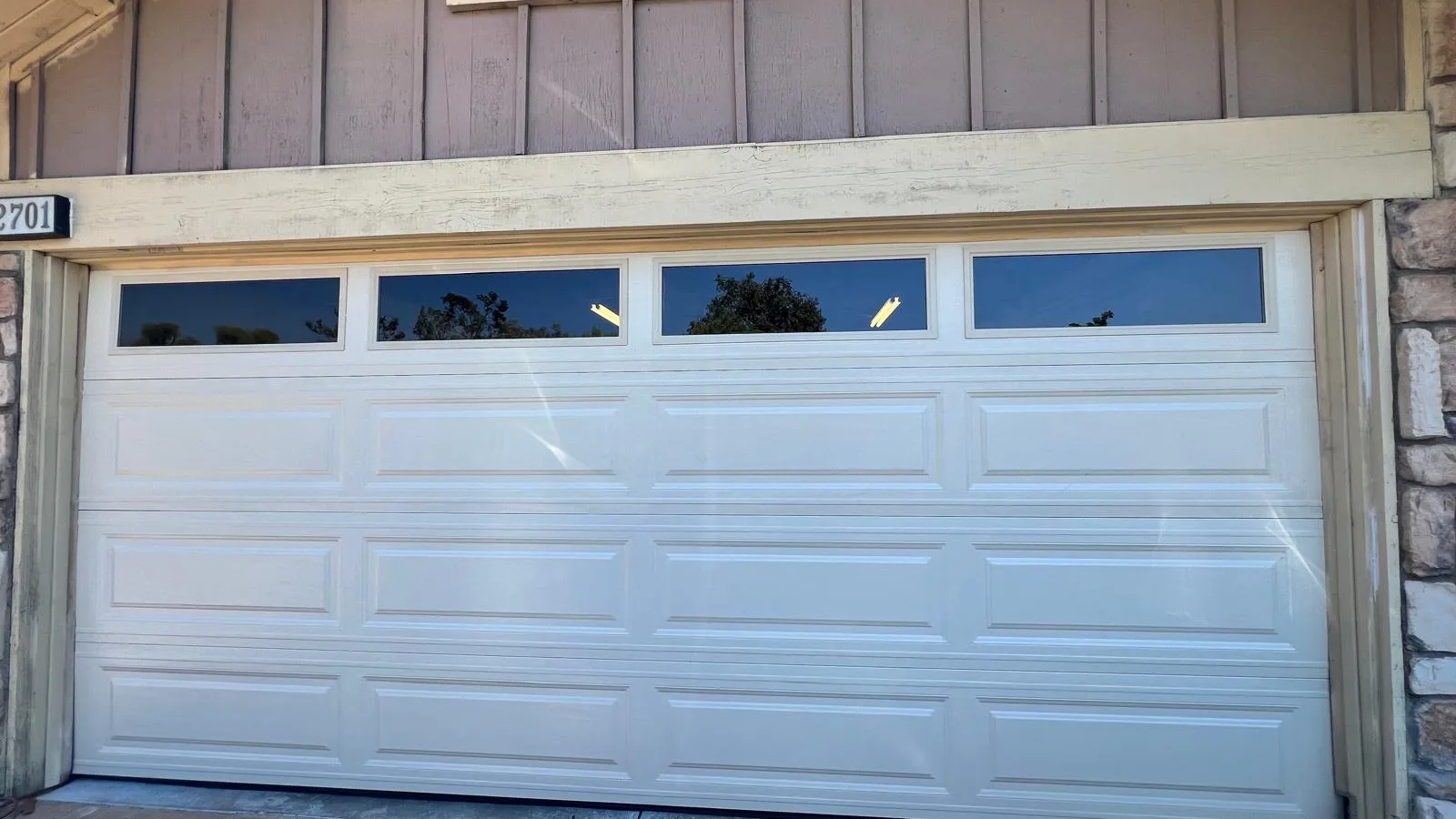 White raised-panel garage door with a row of top windows in Ontario, CA